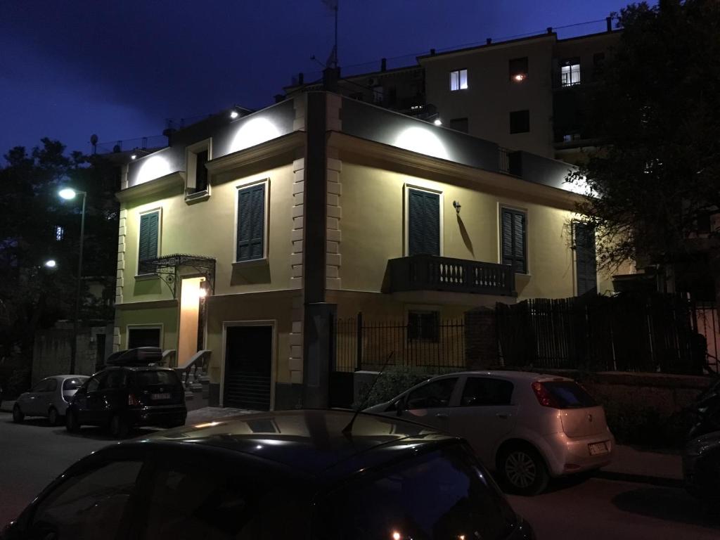 a lit up house with cars parked in front of it at VILLA ROSA in Naples