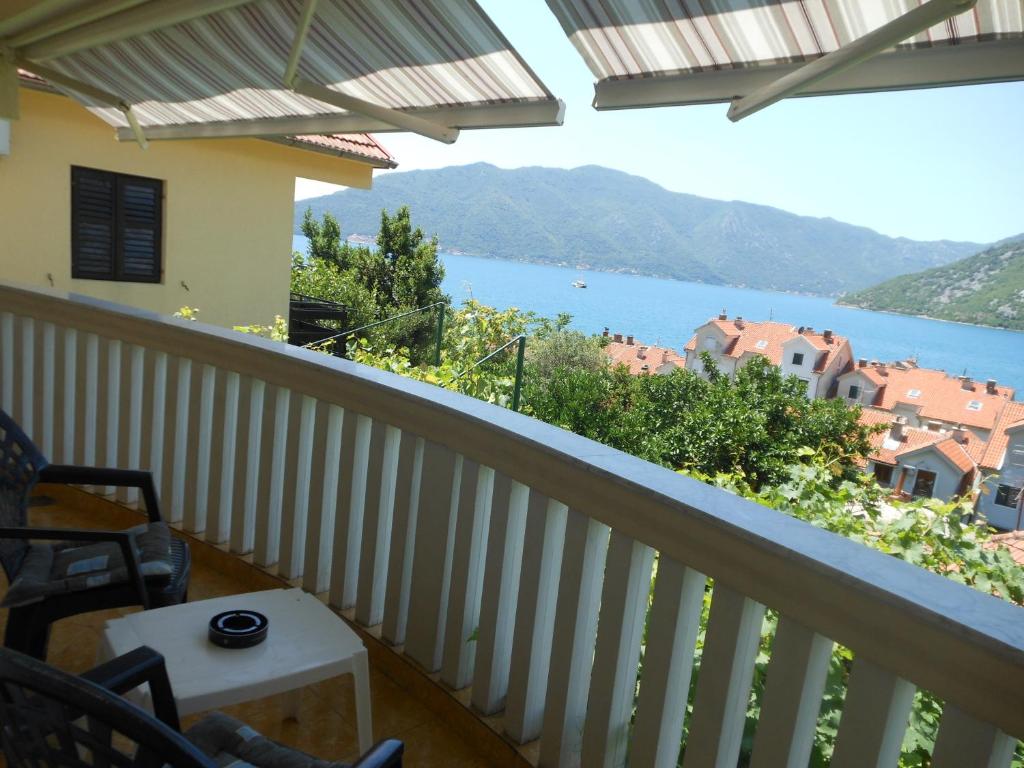 a balcony with a view of a lake at Lorena Rooms in Risan