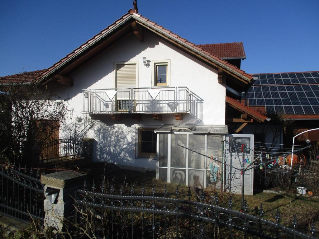 a white house with solar panels in front of it at Haus Anna in Zandt