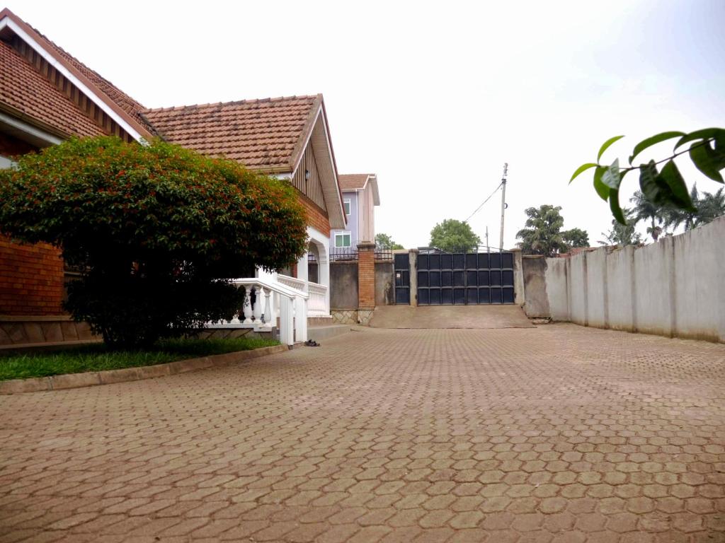 a brick driveway in front of a house at Kampala Kiwatule Comfy Holiday Home in Kampala