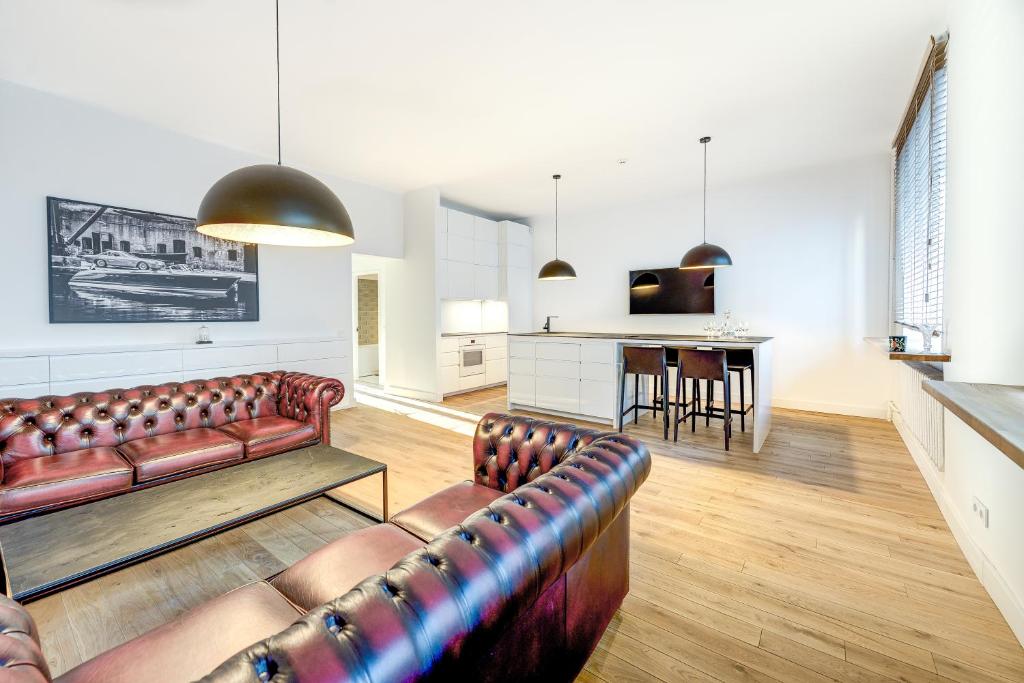 a living room with a couch and a kitchen at Center Apartment, Vilnius, Old Town in Vilnius