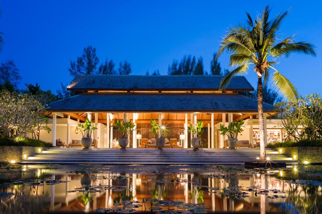 a resort with a pool in front of a building at The Sarojin in Khao Lak
