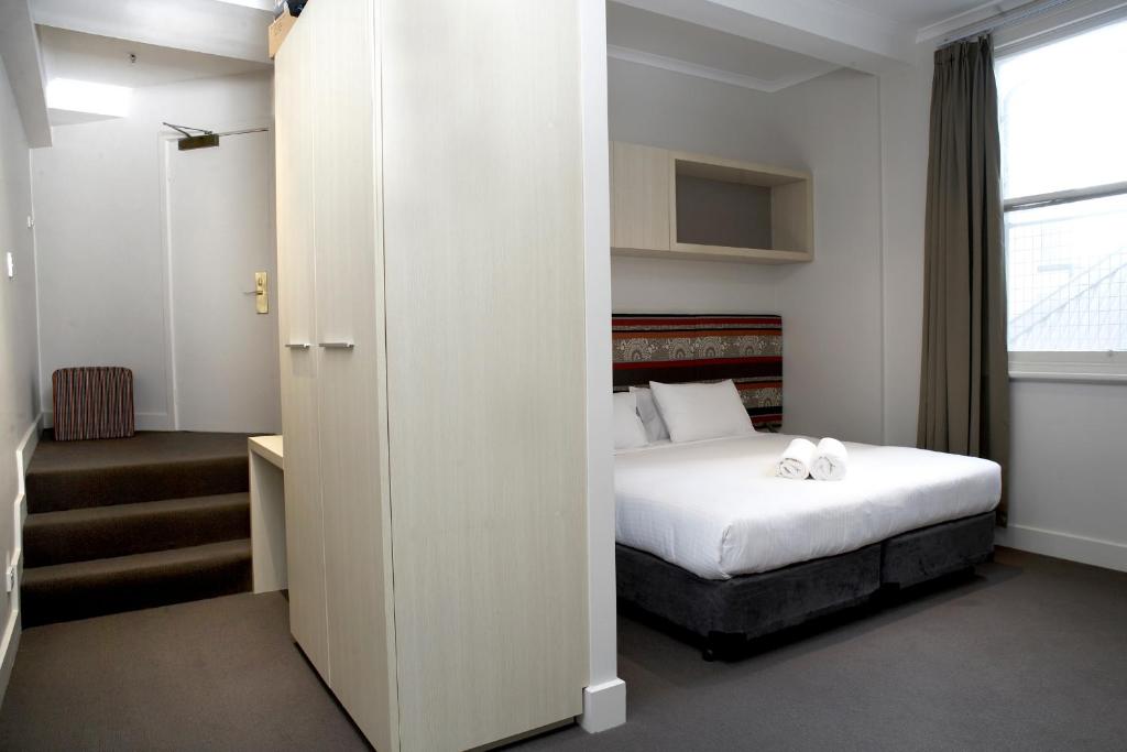 a hotel room with a bed and a window at Best Western Melbourne City in Melbourne