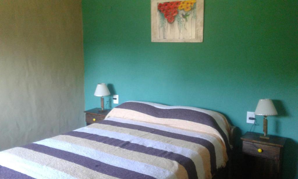 Postel nebo postele na pokoji v ubytování Cabañas Kangarú