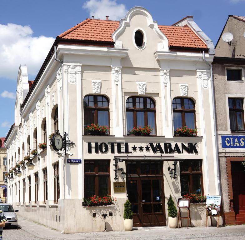 a building with a hotelatown sign in a street at Hotel Vabank in Golub-Dobrzyń