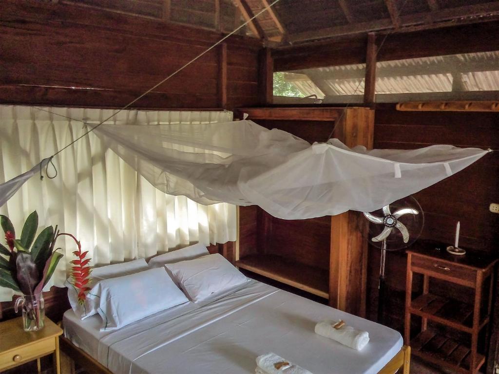 a bedroom with a bed with a mosquito net at Tambopata River in Puerto Maldonado