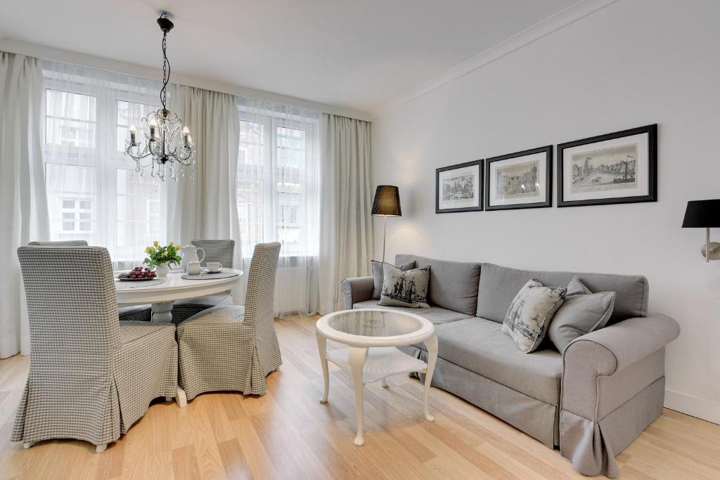 a living room with a couch and a table at BE IN GDANSK Apartments - IN THE HEART OF THE OLD TOWN - Mariacka 31/33 in Gdańsk