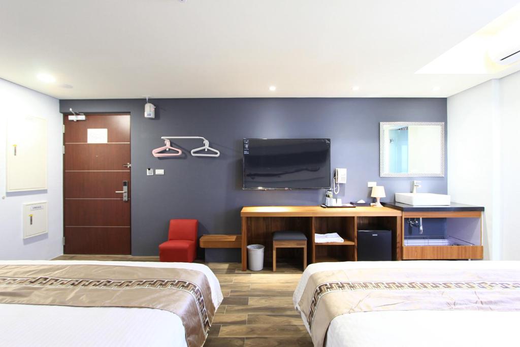 Postel nebo postele na pokoji v ubytování Apause Hotel