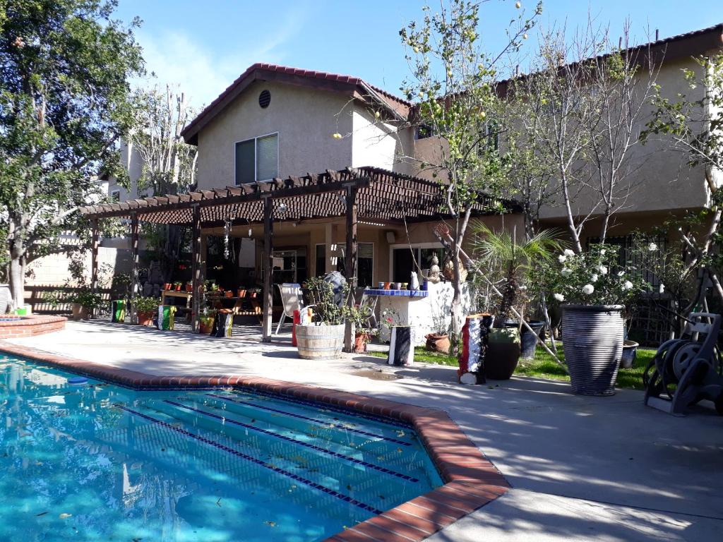 a house with a swimming pool in front of a house at Comfortable Luxury Studio in Los Angeles