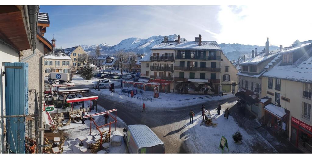 a city with buildings and a river in the snow at Villard-De-Lans - HyperCentre - Place de l'Ours (Libération) - 4 personnes in Villard-de-Lans