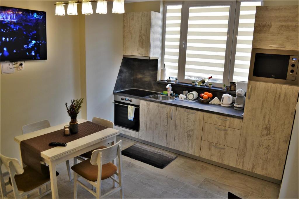 a kitchen with a table and a dining room at Guest Apartment Balkan in Karlovo