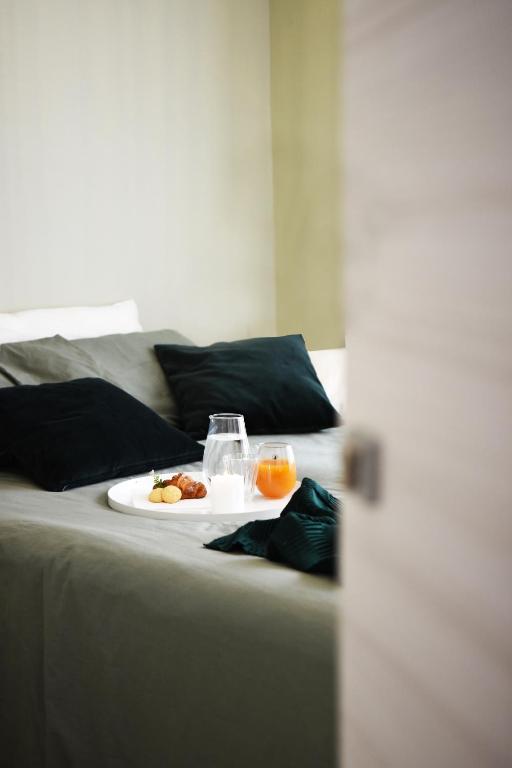 a plate of food on a bed with two drinks at Fabrì 171 in Pescara