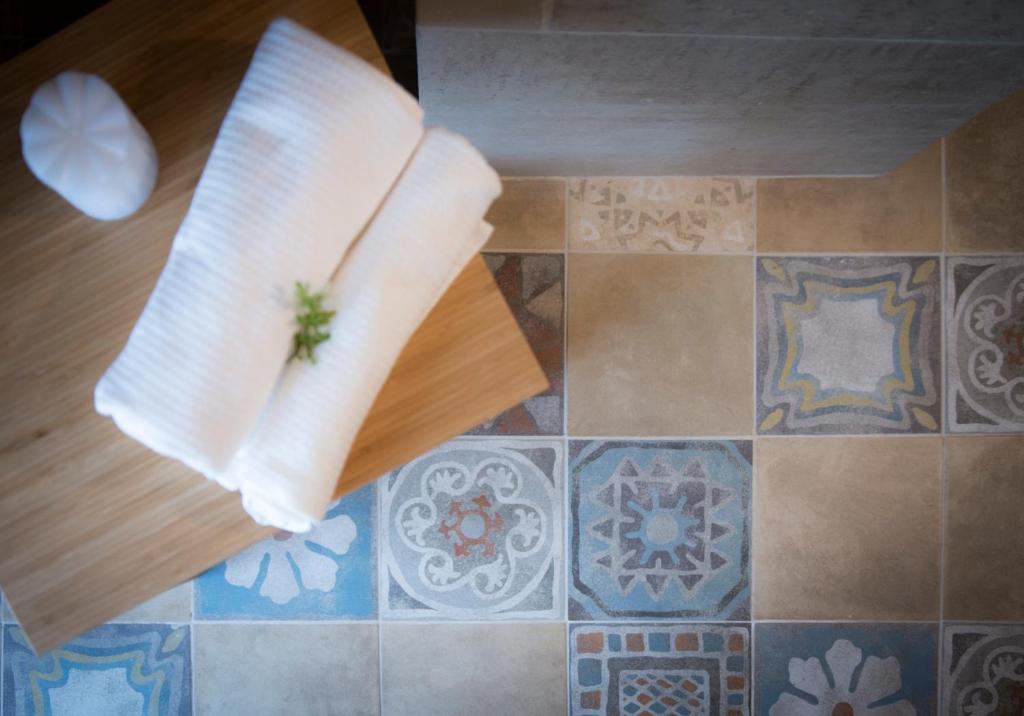 a piece of cheese on a cutting board on a floor at Fabrì 171 in Pescara