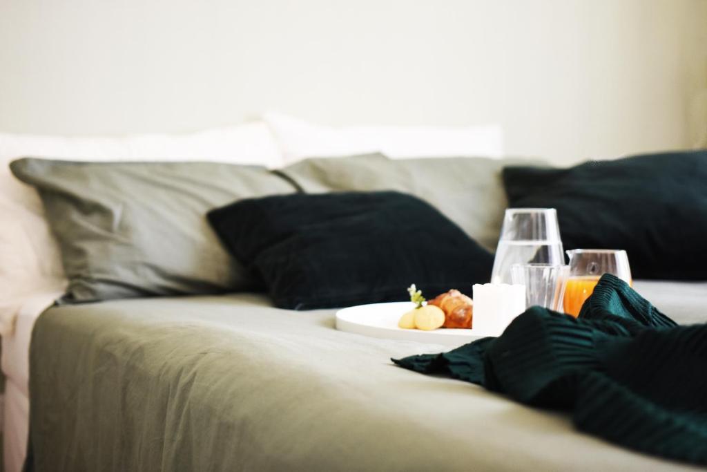 a couch with a plate of food and glasses on it at Fabrì 171 in Pescara