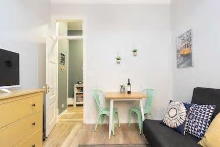 a living room with a table and a couch at Lisbon Charming Apartment in Lisbon