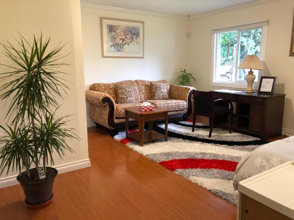 a living room with a couch and a desk at Vancouver shaughnessy guest home in Vancouver