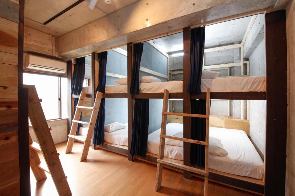 a room with four bunk beds in a cabin at Brücke Arima KOBE in Kobe