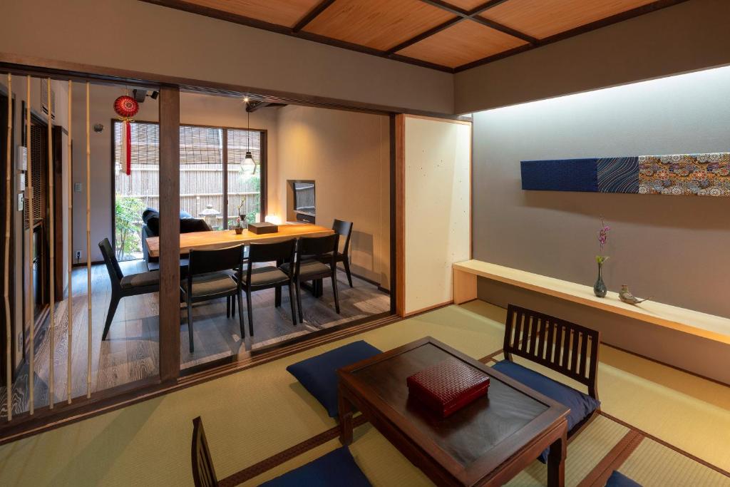 a living room with a table and a dining room at Ainotsuji Machiya House in Kanazawa