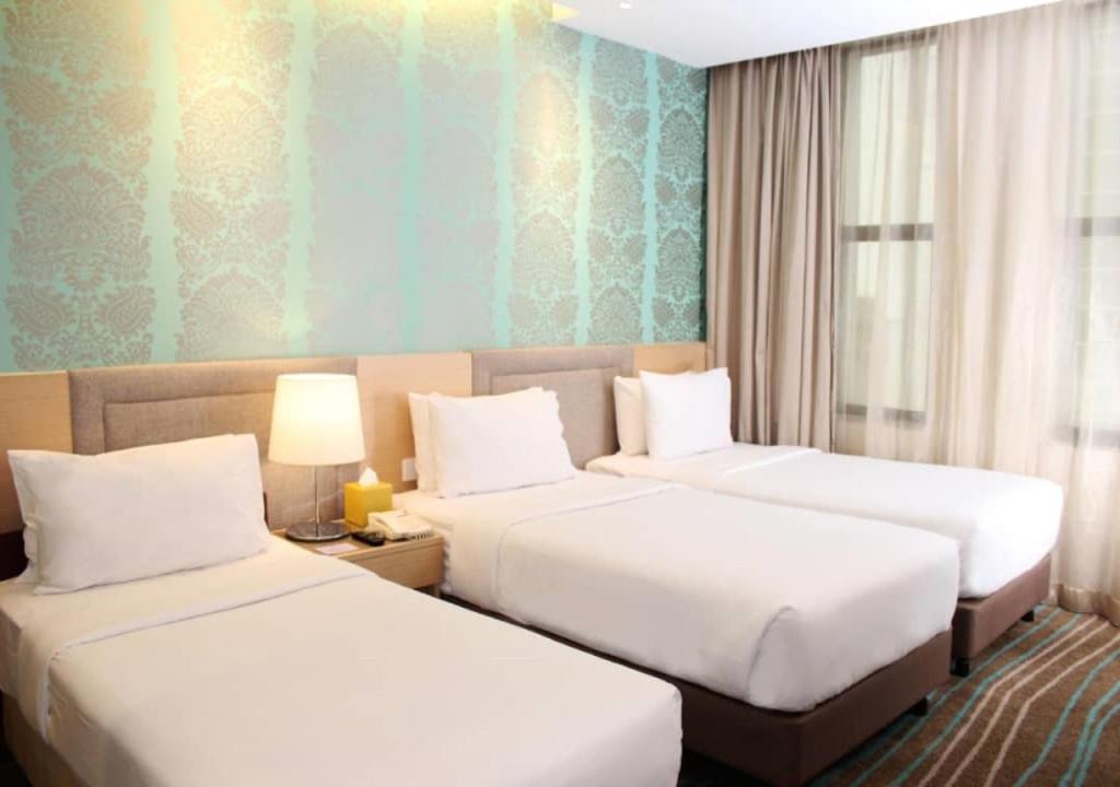 Postel nebo postele na pokoji v ubytování Cosmo Hotel Kuala Lumpur
