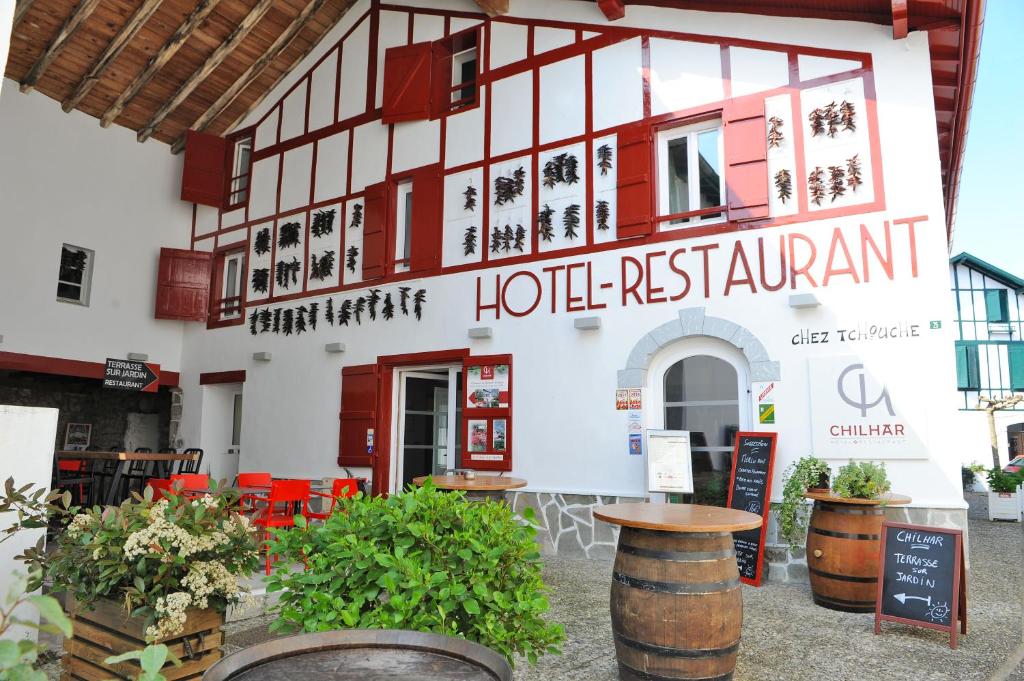 a hotel restaurant with a sign in front of it at Hôtel Chilhar in Espelette