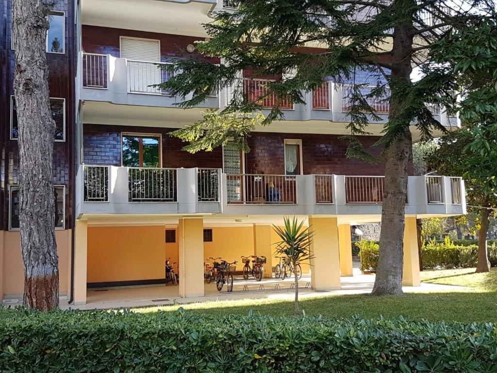 an apartment building with a balcony and a table at Sesia Apartment in Silvi Marina