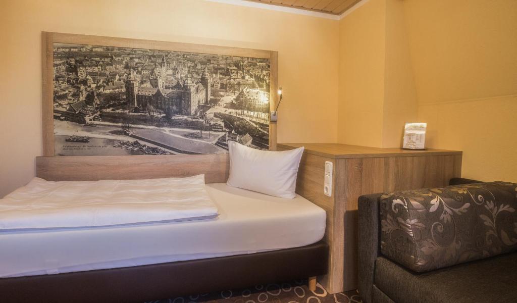 Postel nebo postele na pokoji v ubytování Hotel Wilder Mann