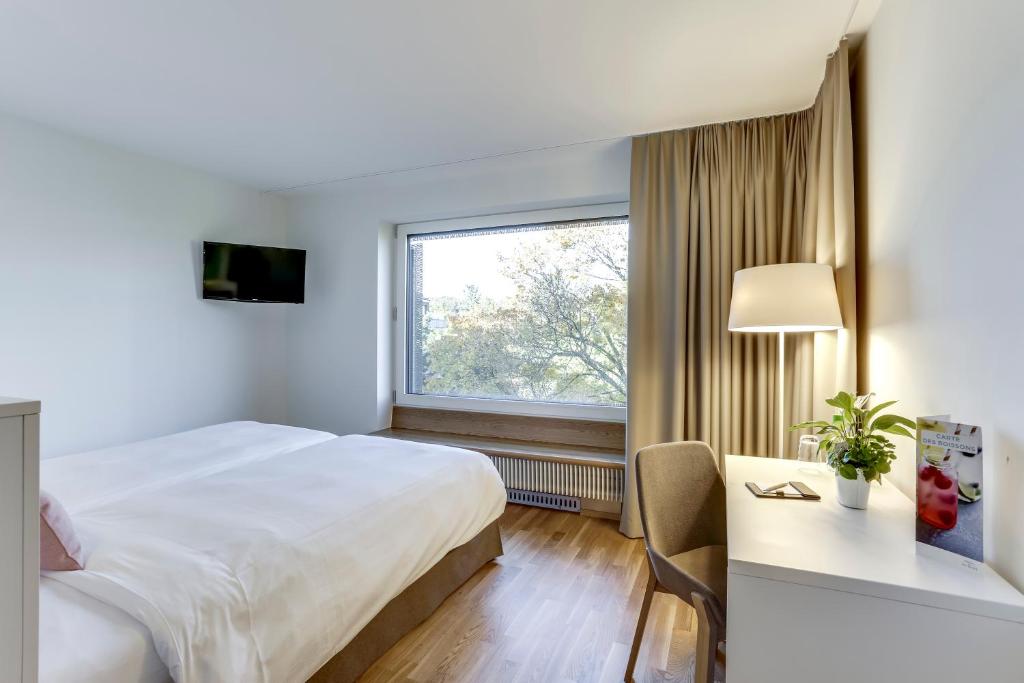 Postel nebo postele na pokoji v ubytování Hôtel des Patients