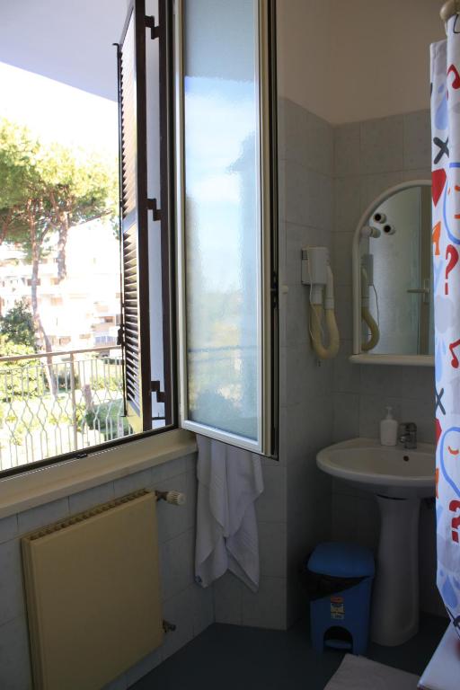 a bathroom with a window next to a sink and a sink at Ostello Villa Monte Mario in Rome