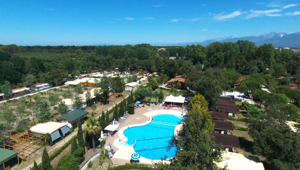 an overhead view of a resort with a large swimming pool at Camping Paradiso in Viareggio