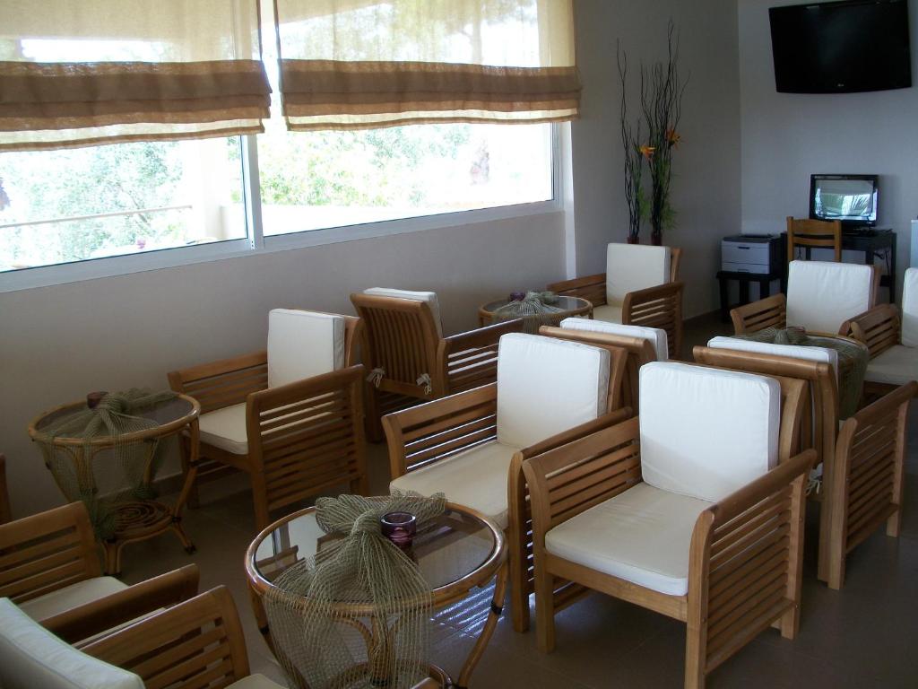 a group of chairs and tables in a room at Thea Hotel in Possidi