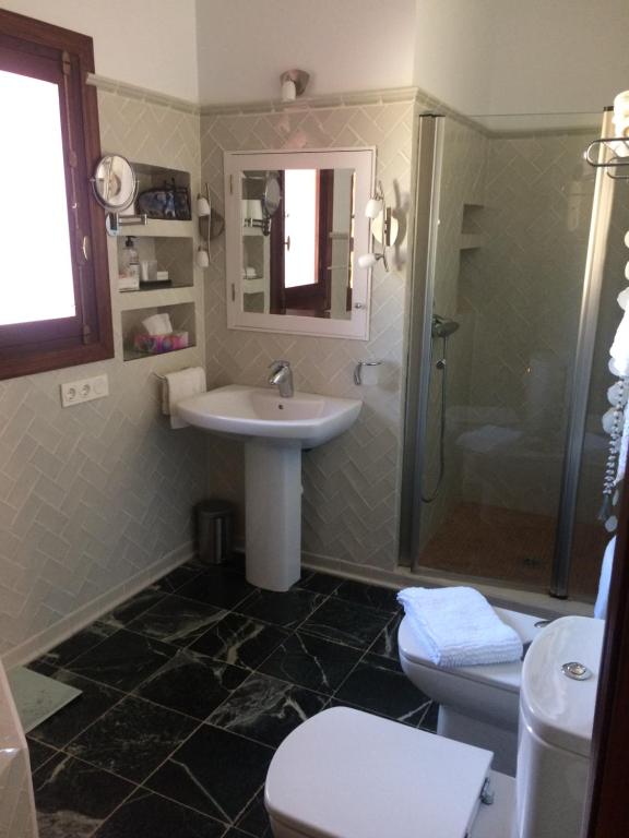 a bathroom with a sink and a toilet and a shower at villaquinta in La Herradura