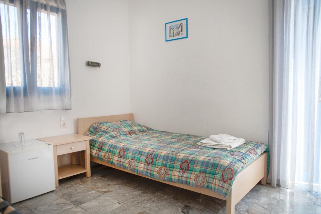 Postel nebo postele na pokoji v ubytování Agios Pavlos Hotel