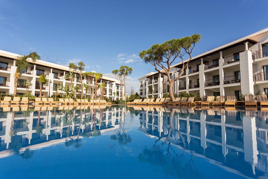 a view of the courtyard of a resort with a swimming pool at Pine Cliffs Gardens in Albufeira