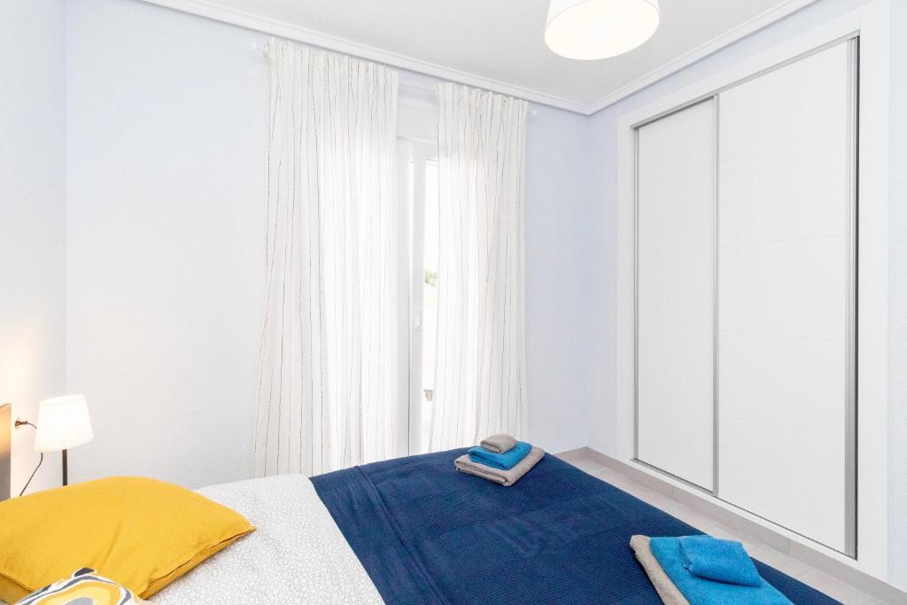 A bed or beds in a room at Luxury La Zenia Beach Apartment