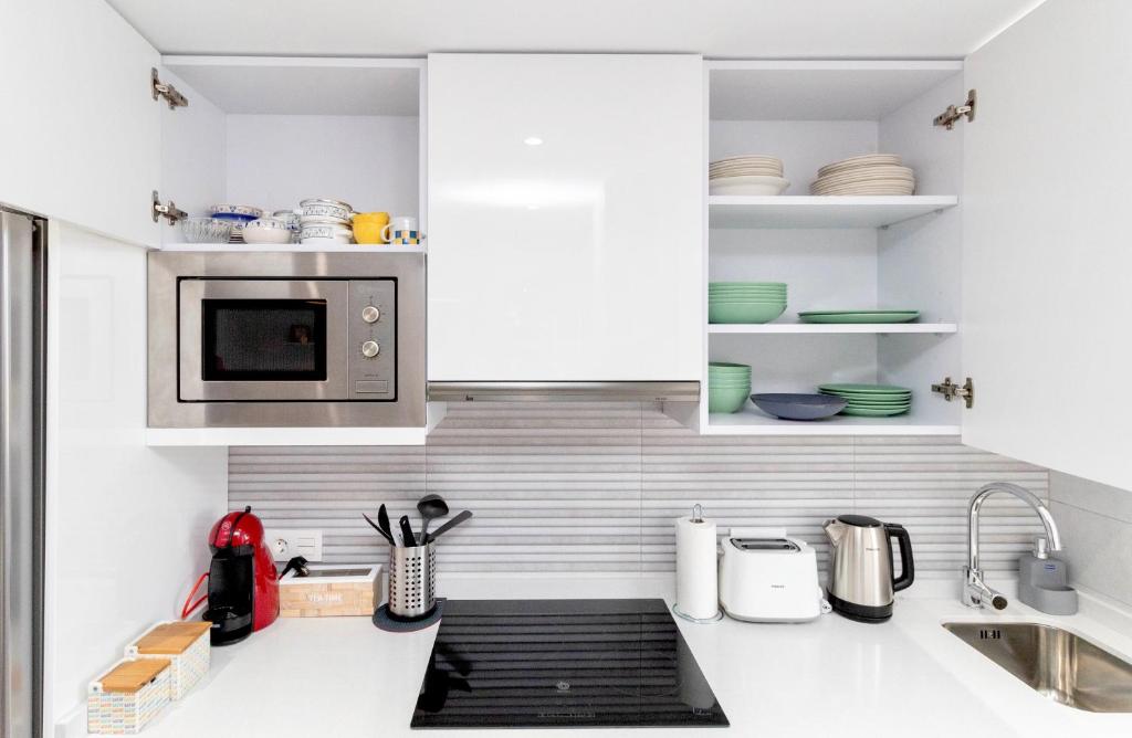 A kitchen or kitchenette at Luxury La Zenia Beach Apartment