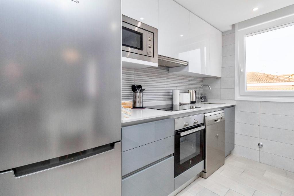 A kitchen or kitchenette at Luxury La Zenia Beach Apartment