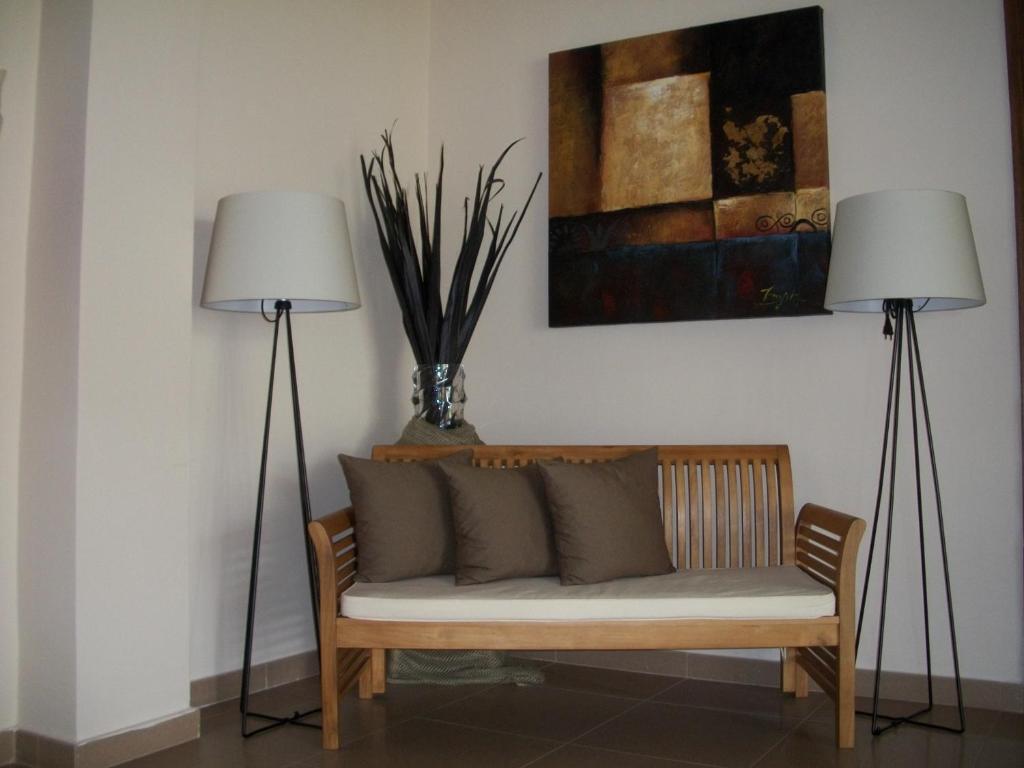 two lamps sitting next to a couch in a room at Thea Hotel in Possidi