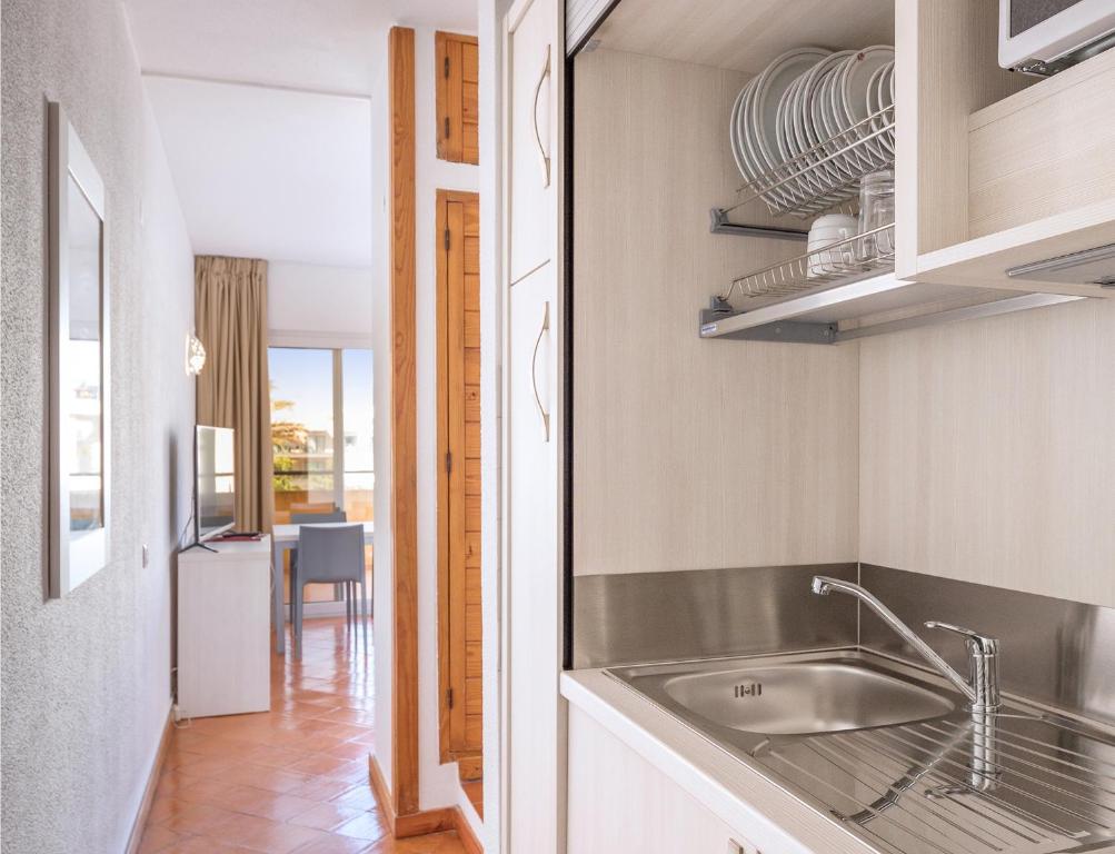 a kitchen with a sink and a table at Dom Pedro Lagos in Lagos