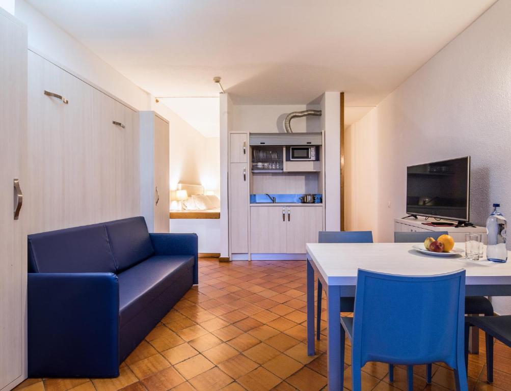 a living room with a couch and a table and chairs at Dom Pedro Lagos in Lagos