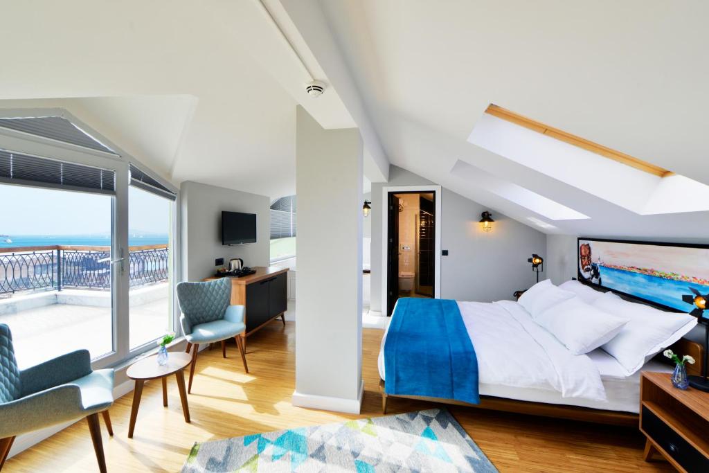 a bedroom with a large bed and a balcony at Hotel Poem in Istanbul