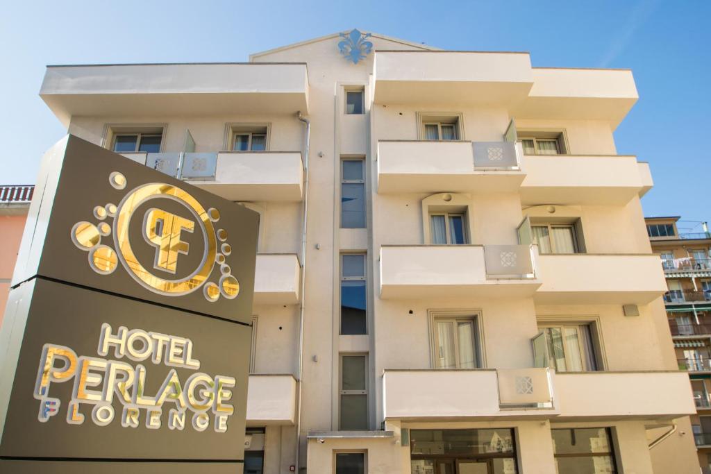 a hotel apartment building with a sign in front of it at Hotel Perlage Florence in Scandicci