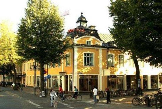 a building with people riding bikes in front of it at Mojo Hotell in Örebro