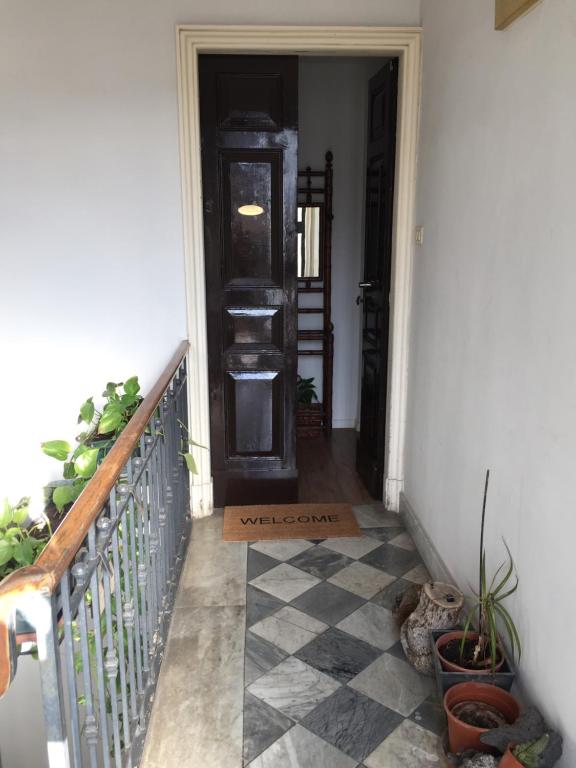 a hallway with a door and a tile floor at The Artist's Home Catania Centro in Catania