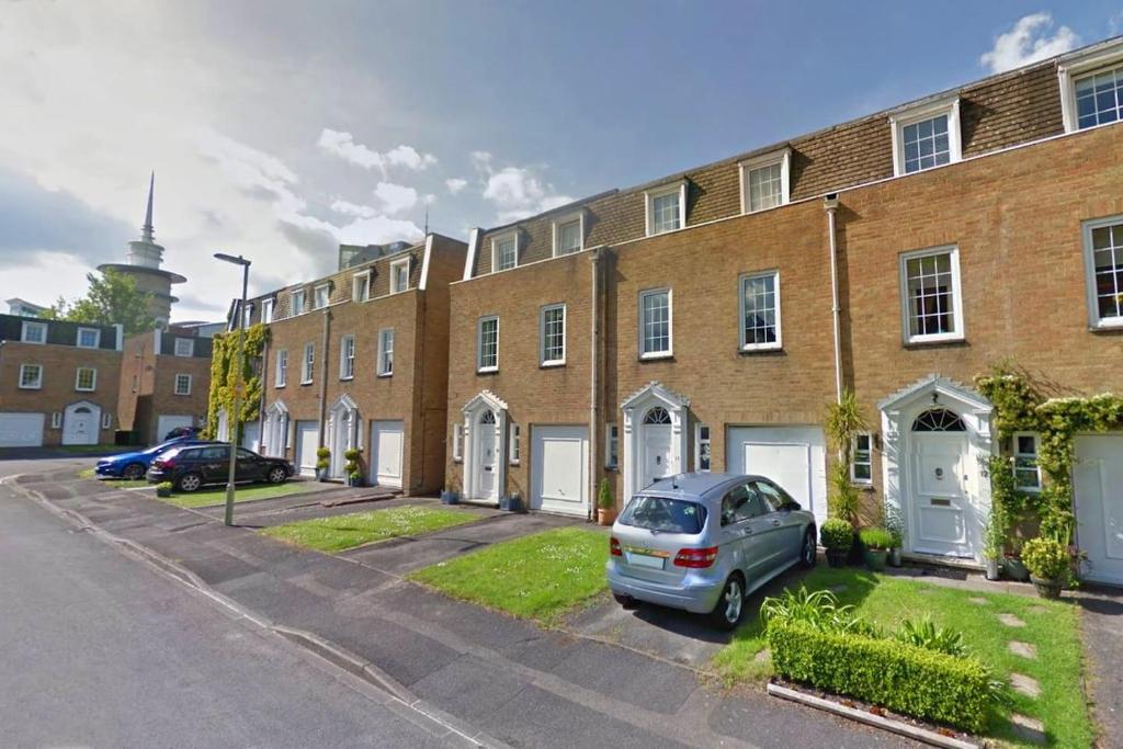 a car parked in front of a brick building at Basingstoke Townhouse in Basingstoke
