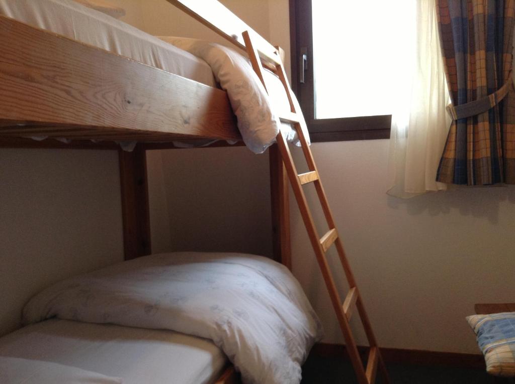 Postel nebo postele na pokoji v ubytování Hôtel Boule de Neige