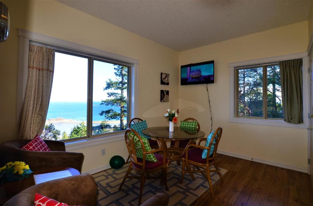 a living room with a table and chairs at Gibralter Rock Ocean View B&B in Nanaimo