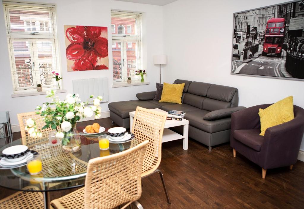 a living room with a couch and a table at Apt 2, Trafalgar Square 2nd Floor by Indigo Flats in London