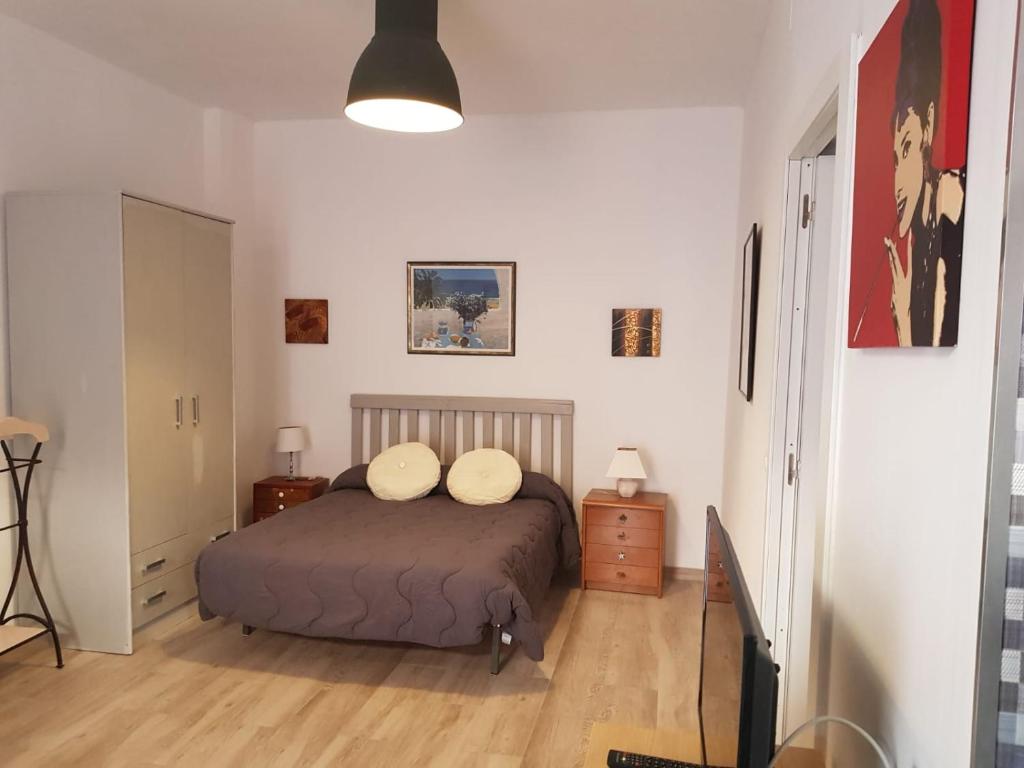 ein Schlafzimmer mit einem Bett mit zwei Kissen darauf in der Unterkunft Estudio 54 Centro in Alicante