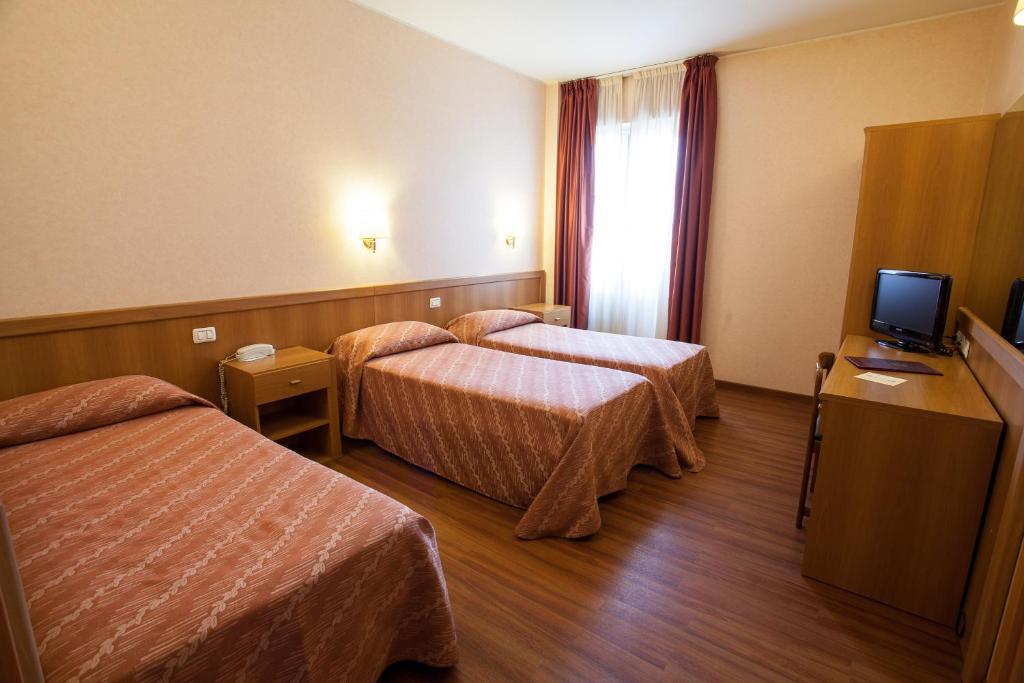 Postel nebo postele na pokoji v ubytování Hotel Esperia