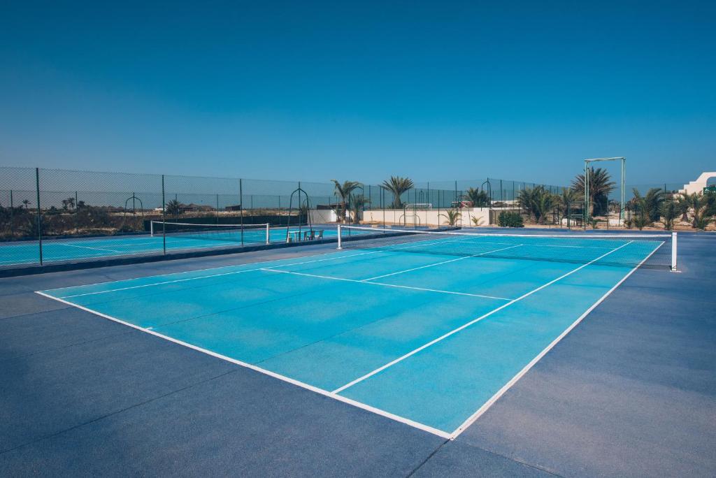 a tennis court with a net on it at Iberostar Waves Mehari Djerba in Taguermess
